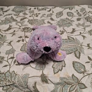 A Pillow Pets Glow Pet seal, pink and purple tie dyed nite lite plush.